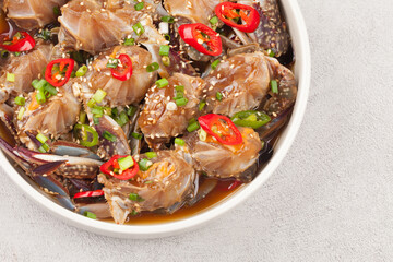  A food made by boiling ingredients such as onions and peppers, then pouring the cooled soy sauce over prepared crabs several times and allowing them to age.

