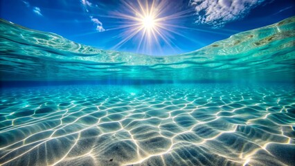 Underwater sunlit ocean. Sandy ocean floor with bright sun shining through the water's surface.