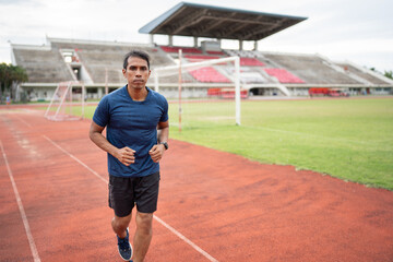 Fototapeta premium Mature fitness Asia man running on racetrack 