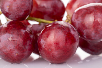 One bunch of juicy grapes, macro, isolated on white background.