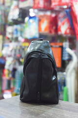 Black chest bag made from synthetic leather. Placed in the middle of many things. Ready to use both yong and man