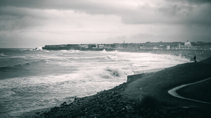 Black and white coastal waves, during bad weather