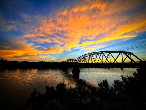 A Majestic Sunset over a Yellowstone River Bridge