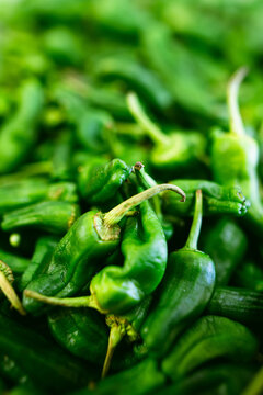 close up of green chili peppers on a stall