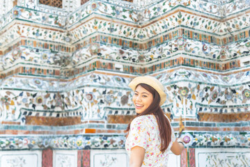 Asian traveller girl take a Wat arun Temple at Bangkok city Thailand - Travel holiday Concept