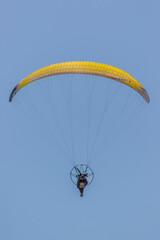 yellow paraglider in the sky