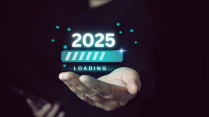 Businessman holding 2025 with loading progress for countdown of merry Christmas and happy new year concept.