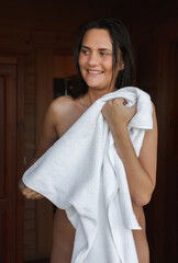 Naked woman wipes herself with a towel after a shower