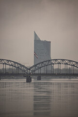 cloudy city with brigde over the river daugava