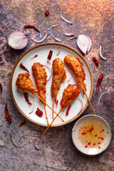 Top view  grilled chicken wings placed on metal grid on gray background