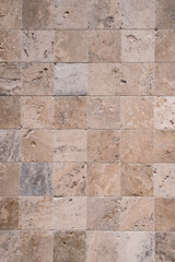Wall with limestone tiles closeup as stone background
