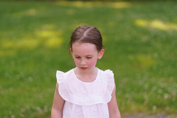 A cheerful preschooler, one tooth absent, enjoying a sun-soaked day at the playground.