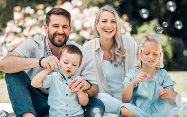 Smile, family and blowing bubbles in garden at home with fun, bonding and support with care. Parents, kids and happy on portrait for child development or growth in outdoor with love and learning