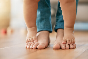 First steps, feet and baby with mom for trust, growth and guidance in living room. Person, toddler...