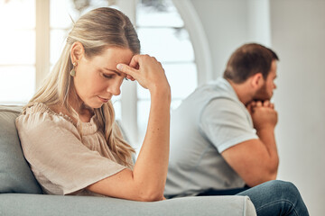 Couple, fighting and woman frustrated on sofa, marriage issue and conflict resolution in home....