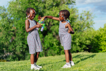 Obraz premium Two happy girls playing and enjoying in the park