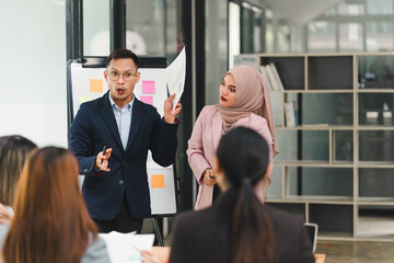 Professional diverse business team presenting and discussing data charts and graphs during meeting in modern office.