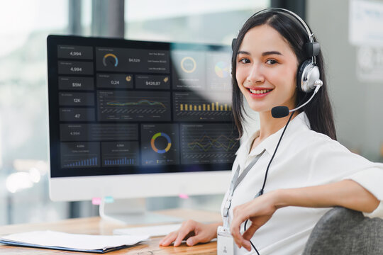 Operator wearing a headset, using a dashboard on laptop for data analysis in modern office. - Powered by Adobe