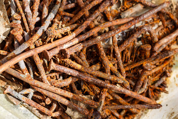 Bent rusty nails pulled out of boards folded into a jar