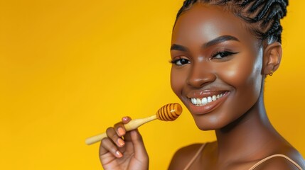 Smiling woman with honey dipper on yellow background