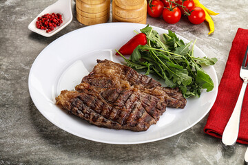 Grilled chuck roll steak with arugula