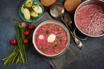 Traditional Belorussian, Latvian, Lithuanian, Polish, Russian and Ukrainian Beetroot cold creamy soup with cucumber, radish, potatoes and egg . Summer soup concept