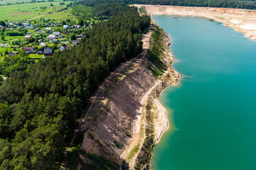 A large flooded sand quarry bordering the village, aerial view. Bolotsky quarry, Kaluga region