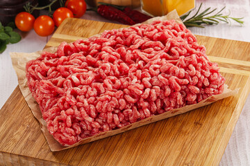Raw minced beef meat over board
