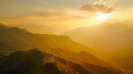 Majestic mountains and sunrise with delicate fog hanging over the mountains.