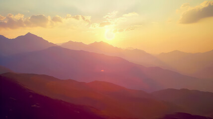 Obraz premium Majestic mountains and sunrise with delicate fog hanging over the mountains.