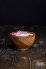 vanilla and raspberry flavored yogurt in a wooden bowl