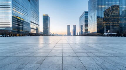 Fototapeta premium Tranquil empty square with skyscrapers silhouetted in the dusk light, downtown city skyline in the background, no vehicles or people visible