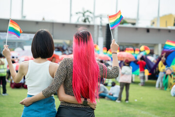 Celebrate in pride month festival. Pride movement transgender asian couple lesbian LGBT holding...