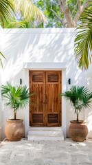Fototapeta premium A close-up view of a white front door with decorative molding, a silver door handle, and potted plants on either side