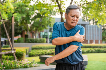 Senior asian old man with sportswear has an inflamed arm. Old man senior has problem with structural posture