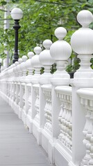 A white balustrade fence with decorative sphere finials extends across a lush garden with white flowers and green shrubs