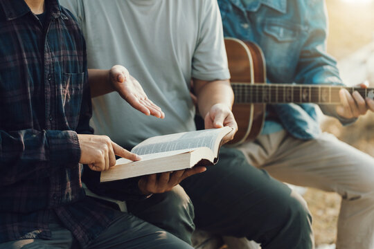 Christian Bible Study Concepts. Christian friend groups read and study the bible together in the park. sharing the gospel with a friend. followers are learning the word of God. praying to God.