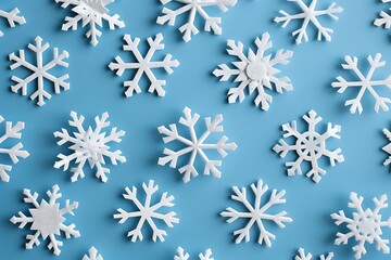 A pattern of minimalist, white snowflakes on a cool blue background