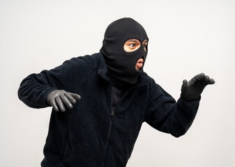 Thief in uniform black jacket various pose on isolated background. The Robber terrorism criminal escapes with balaclava and crowbar entering a house for stealing Housebreak