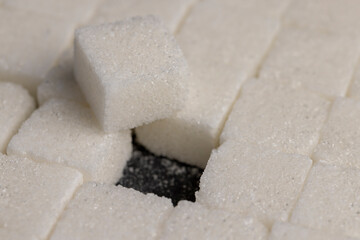 white square sugar on a black background