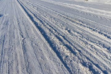 a road covered with snow that is dangerous for motor vehicles