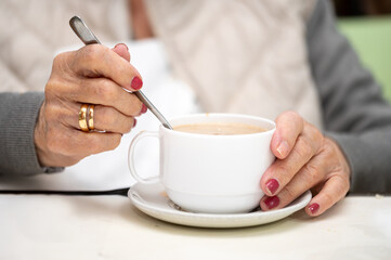 Close up of elderly woman enjoying breakfast. High quality photo