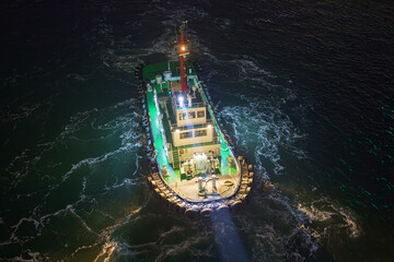 Aerial view of the tugboat with lights on, at nighttime, Incheon, South Korea