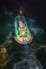 Aerial view of the tugboat with lights on, at nighttime, Incheon, South Korea