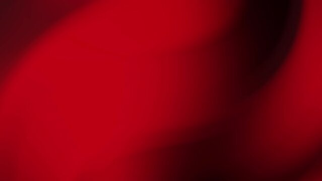 Dark red gradient background with blurred, wavy pattern suitable for abstract designs, backgrounds, textures, and graphic overlays in various projects.