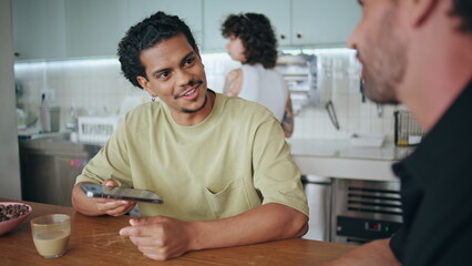 Men exchange phone numbers after acquaintance in cafeteria closeup. Meeting cafe