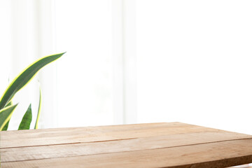 Wooden board and free space for decoration. Kitchen interier. Sunny natural light and window shade. Space for a mockup of your products.