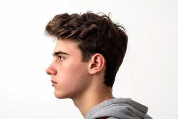 Fototapeta premium A young adult looking away, wearing a grey hoodie