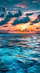 Captivating Maldives sunset over the Indian Ocean, featuring blue water, white clouds, and vibrant sky