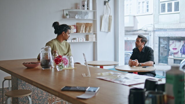 Two male strangers talking meeting in coffee house at weekend. Guys acquaintance